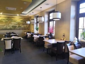 a dining room with tables and chairs and windows at Sun-House Pension - ParkingFree Limited spaces- in Prague