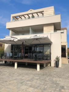 - une terrasse avec des chaises et un parasol dans l'établissement Rooms & Restaurant Matanovi Dvori, à Sukošan