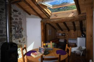 ein Wohnzimmer mit einem Tisch und einem Dachfenster in der Unterkunft Arcogite in Vicdessos