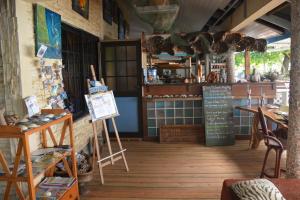 a shop with a chalkboard in the middle of a room at Fare Maheata in Pihaena +37 photos