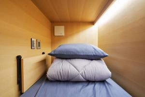 Ein Bett oder Betten in einem Zimmer der Unterkunft THE CAPSULE Myeongdong