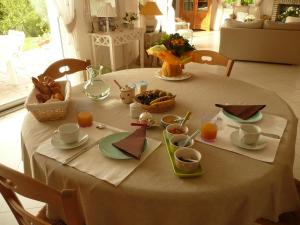 a table with a white table cloth with food on it at Chambre d'Hotes Pause en Chemin in Condette