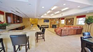 a large living room with a bar and a couch at Honu Hideaway at Ocean Walk Resort in New Smyrna Beach