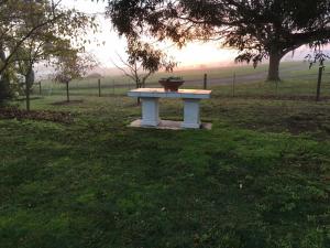 a white table in the middle of a field at The Gatehouse at Villa Raedward in Yering
