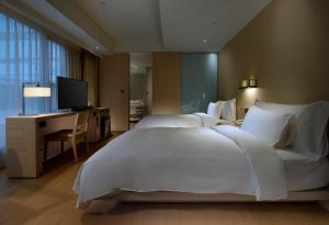 Postel nebo postele na pokoji v ubytování Chihpen Century Hotel