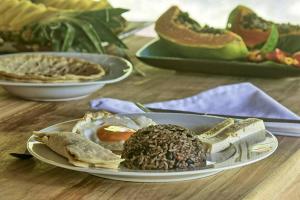 a plate of breakfast foods on a table at Rincon Verde in Bijagua