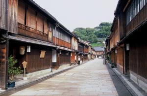 an empty street in an asian village with buildings at KKR Hotel Kanazawa in Kanazawa