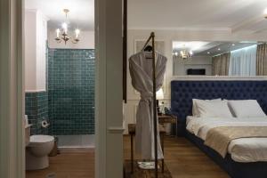 a bedroom with a bed and a bathroom with a shower at Omart Hotel - Gallery in Tbilisi City