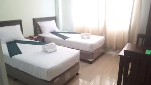 Katil atau katil-katil dalam bilik di Adams View Hotel