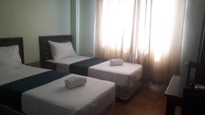 Katil atau katil-katil dalam bilik di Adams View Hotel
