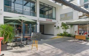 a building with an umbrella and a chalkboard in front of it at Aurora Serviced Apartments in Ho Chi Minh City