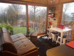 a living room with a couch and a table at La mignonne des fagnes in Malmedy