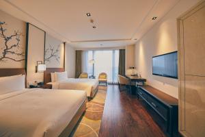 Ένα ή περισσότερα κρεβάτια σε δωμάτιο στο LJZ Supreme Tower Hotel