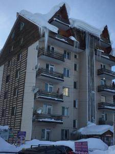 a large apartment building with icicles hanging from it at Ski Sun & Fun - next to iconic Marco Polo in Gudauri