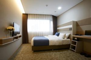 מיטה או מיטות בחדר ב-The Recenz Dongdaemun Hotel