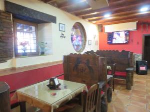 a restaurant with chairs and a table in a room at Hotel Rural Vistahermosa in Béjar