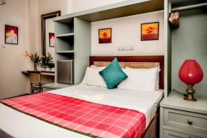 A bed or beds in a room at Small House Boutique Guest House 