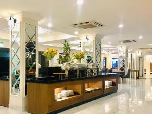 a store with a counter with flowers on it at Saigon Tourane Hotel in Danang