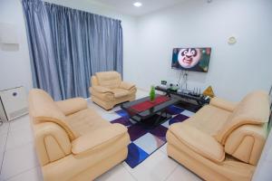 a living room with two chairs and a table at THE ONLY SEA VIEW IN TOWN in Kuah