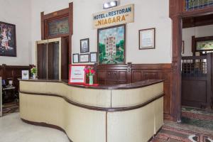 a lobby with a reception counter in a building at RedDoorz @ Lawang in Malang