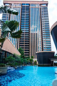 a large swimming pool in front of a tall building at The Apartments at Times Square Kuala Lumpur KL in Kuala Lumpur