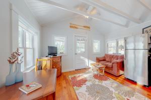 a living room with a couch and a table at ​Lake Time Cottage in Orland
