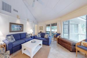 a living room with blue couches and a table at Night Heron 18 in Hilton Head Island