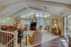 a living room filled with furniture and a tv at Alexander Beach House in Hilton Head Island