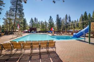 a swimming pool with chairs and a slide at Happy Family Cozy Cabin in Truckee