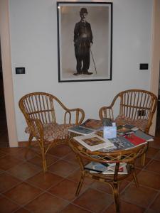 una habitación con mesa y sillas y una foto de un hombre en Charlie Chaplin, en Tamara