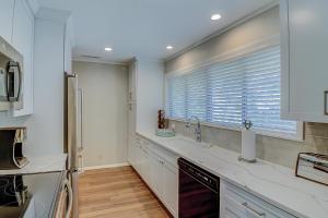 a kitchen with white cabinets and a window with a sink at Alexander Beach House in Hilton Head Island +51 photos