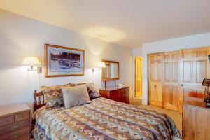 a bedroom with a bed and a wooden door at Silver Bow 65 in Big Sky +12 photos