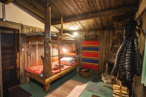 a bedroom with a bunk bed in a cabin at Tankavaara Gold Village in Tankavaara