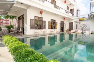 a swimming pool in front of a building at Horizon 2 villa in Hoi An