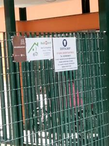 a metal fence with signs on it in a store at B&B Metrò in Bussero