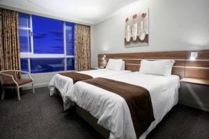 a hotel room with a large bed and a window at Hotel Osner in East London