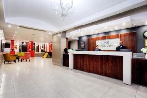 a lobby of a hotel with a reception desk at Hotel Osner in East London