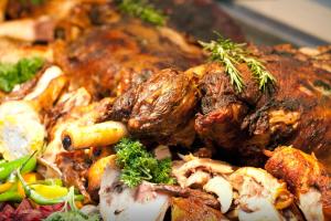 a plate of food with meat and vegetables at Hotel Osner in East London