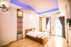 a bedroom with a bed and a blue ceiling at SUNNY HOTEL in Quy Nhon