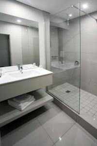 a bathroom with a sink and a shower at Hotel Osner in East London