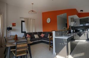 a kitchen and living room with a couch and a table at LE BELVÉDÈRE in LʼEntre-Deux +13 photos