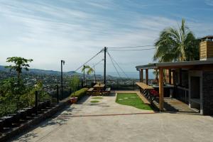 a house with a balcony with a view of the city at LE BELVÉDÈRE in LʼEntre-Deux