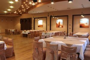 a banquet hall with tables and chairs and lights at Hotel Briz 3 - Free Parking in Varna City