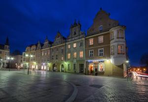 a large building in a city at night at White Vision Apartment in Opole +6 photos