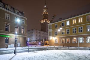 a clock tower in the middle of a city at White Vision Apartment in Opole