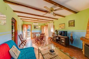 a living room with a ceiling fan and a couch at Casa Rural Valle del Arrago in Robledillo de Gata