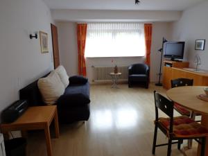 a living room with a couch and a table at Haus am Weinberg in Endingen