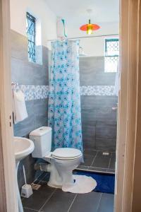 a bathroom with a toilet and a shower at Serene Homes in Mombasa