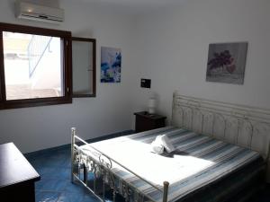 a bedroom with a bed with a mirror and a window at Villetta Residence Chiusurelle in Porto Cesareo +33 photos