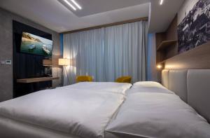 Postel nebo postele na pokoji v ubytování Hotel Grand